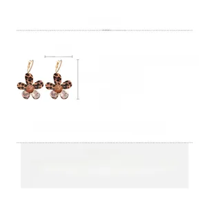 Detail of five-petal flower earring with leopard print texture and 18K gold plated metal