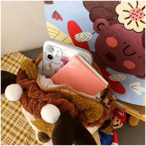 Detail of cute lion plush crossbody bag with golden chain strap and interior storage space