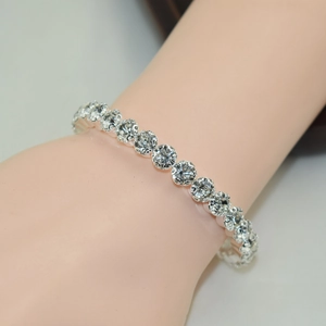 Elegant single row rhinestone open bracelet in silver finish worn on a wrist