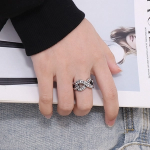 Detailed view of infinity symbol ring in vintage silver finish with sparkling stones
