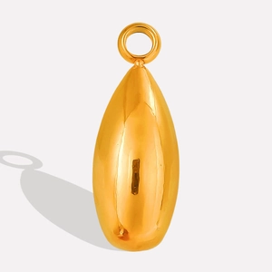 Close-up of polished gold teardrop pendant with reflective mirror finish and top ring
