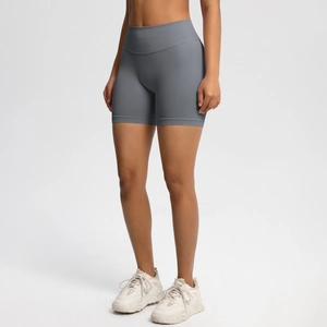 Detailed view of seamless high-waisted dark grey gym shorts with peach lift effect