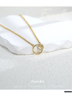 Detailed close-up of double interlocking rings necklace with micro-pave zircons and gold plating