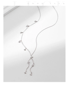 Close-up of S925 sterling silver star fringe necklace with sparkling crystal charms