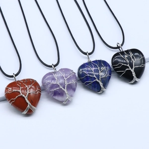 Set of heart-shaped crystal tree of life pendants in amethyst, quartz and obsidian