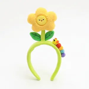 Cute green plush headband with a smiling sunflower and colorful caterpillar design