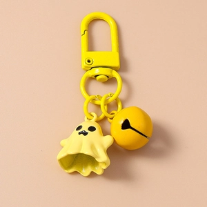 Detailed macro view of yellow ghost keychain with bell and spring clasp accessory