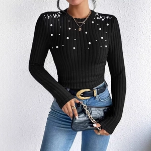 Close-up of black ribbed long-sleeve knit top featuring elegant pearl embellishments