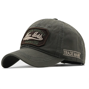Close-up of olive green washed cotton baseball cap with 3D New York embroidery detail