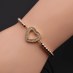 Detail of multi-color beaded bracelet with sparkling heart zircon worn on wrist
