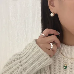 Detail of S925 sterling silver ball earrings paired with heart malachite pendant necklace