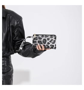 Detailed view of the leopard print wristlet bag with gold zipper and stylish wrist strap