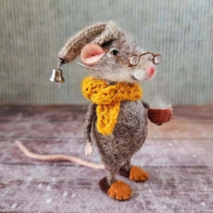 Close-up of a handmade needle-felted mouse figurine wearing metal glasses and a yellow scarf