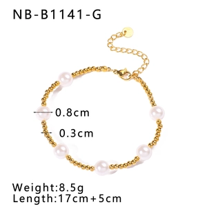 Detail view of a gold beaded bracelet with white pearls showing size and length specs