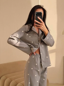 Gray heart print pajama set with long sleeve button-down top and matching trousers