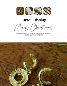 Detailed macro view of C-shaped Christmas stud earrings featuring Santa and reindeer motifs