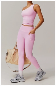 Detail of pink one-shoulder yoga top and high-waisted leggings with side phone pocket