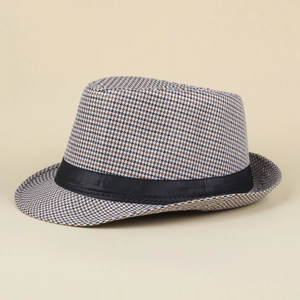 Detailed close-up of houndstooth jazz hat with a black satin decorative ribbon