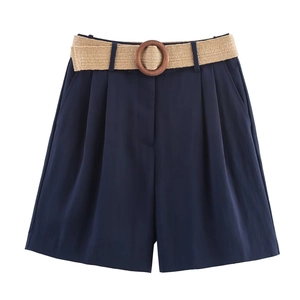 Detailed close-up of dark blue casual high-waisted shorts with a woven belt and wooden buckle