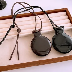 Minimalist resin droplet pendant necklaces with leather cords in black and brown