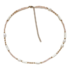 Handmade necklace with baroque pearls, pink crystals, and golden beads on white background
