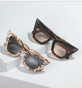 Close-up of retro cat-eye sunglasses in tortoiseshell and cream marble patterns