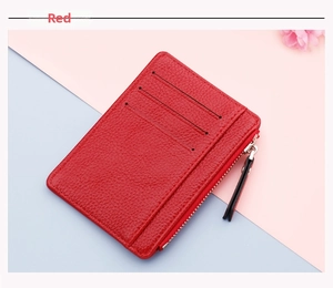 Detail of red slim card holder featuring lychee grain leather and zippered coin pocket