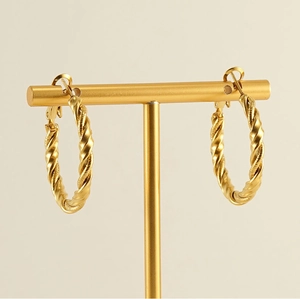 Macro detail of twisted rope texture on 18k gold plated stainless steel hoop earrings