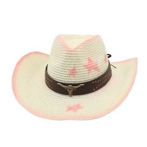 Close-up of cowboy straw hat featuring pink star print and vintage golden bull head buckle