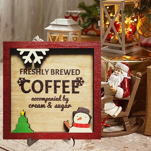 Detail of wooden coffee sign featuring a snowman and Christmas tree with a metal stand