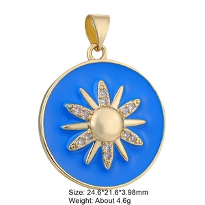Macro detail of blue enamel starburst pendant with gold frame and crystal stone