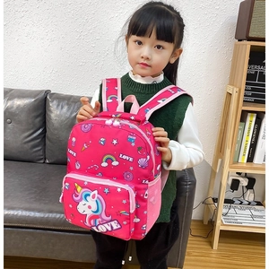 Pink cartoon unicorn backpack with rainbow patterns worn by a little girl for school