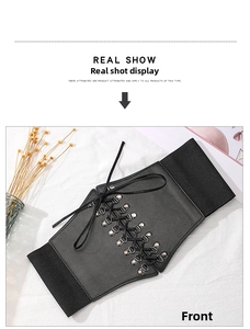 Close-up of women's black lace-up corset belt with metal eyelets and elastic band