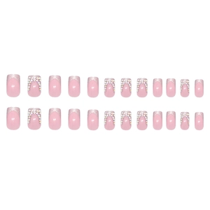 Sparkly French press-on nails set with pink base, silver glitter tips and crystal accents