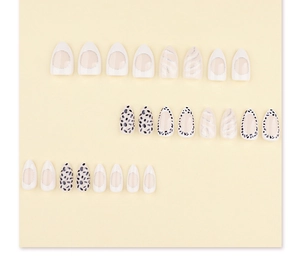Detail of almond-shaped press-on nails with leopard spots and silver glitter trim
