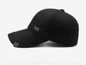 Detailed side view of black baseball cap featuring a metal SPORT logo and twill texture