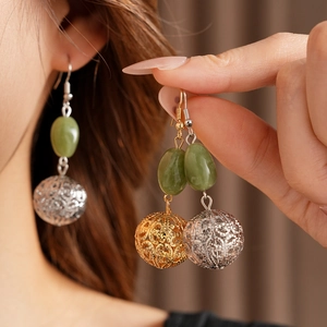 Detailed comparison of gold and silver resin hollow ball drop earrings on model