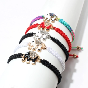 Detailed macro of handmade woven elephant bracelets with colorful rhinestones and enamel charms