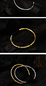 Close-up of irregular textured S925 silver bangles in gold and silver finishes