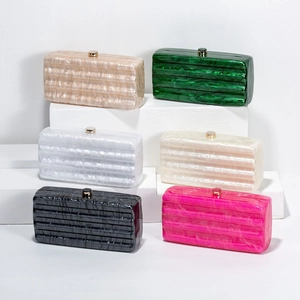 Multiple colorful acrylic evening clutch bags with marble texture and gold metal clasps
