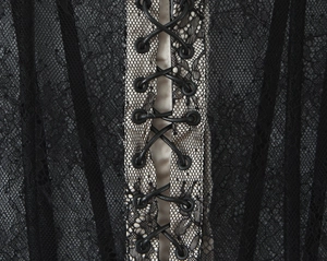 Detailed view of lace mesh and metal eyelet lace-up corset with intricate stitching