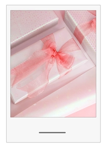 Pink gift wrapping paper with gold star patterns and matching organza ribbon bow detail