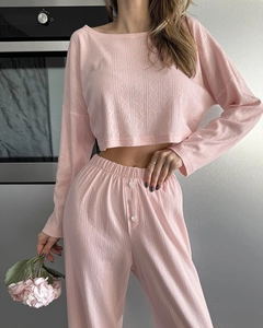 Close-up of pink knit loungewear featuring pointelle texture and button details