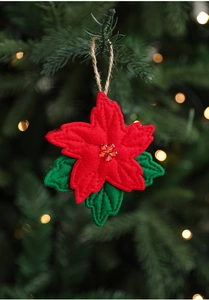 Detail of red and green felt flower ornament hanging on a Christmas tree branch