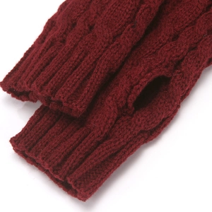 Close-up of wine red cable knit fingerless gloves showing detailed ribbed cuff texture