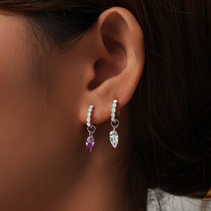 Detail of 925 sterling silver geometric water drop earrings with purple and clear stones