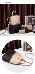 Detail of four-piece black and gold Saffiano leather backpack set with tassel charms