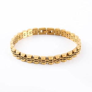 Detailed close-up of polished gold stainless steel bracelet with watchband style links