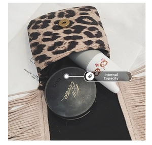 Detail view of leopard print mini pouch showing interior capacity with magnetic gold clasp
