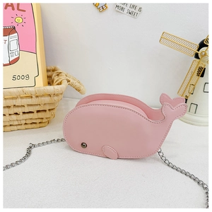 Detailed view of pink dolphin PU bag for kids with silver chain strap on props